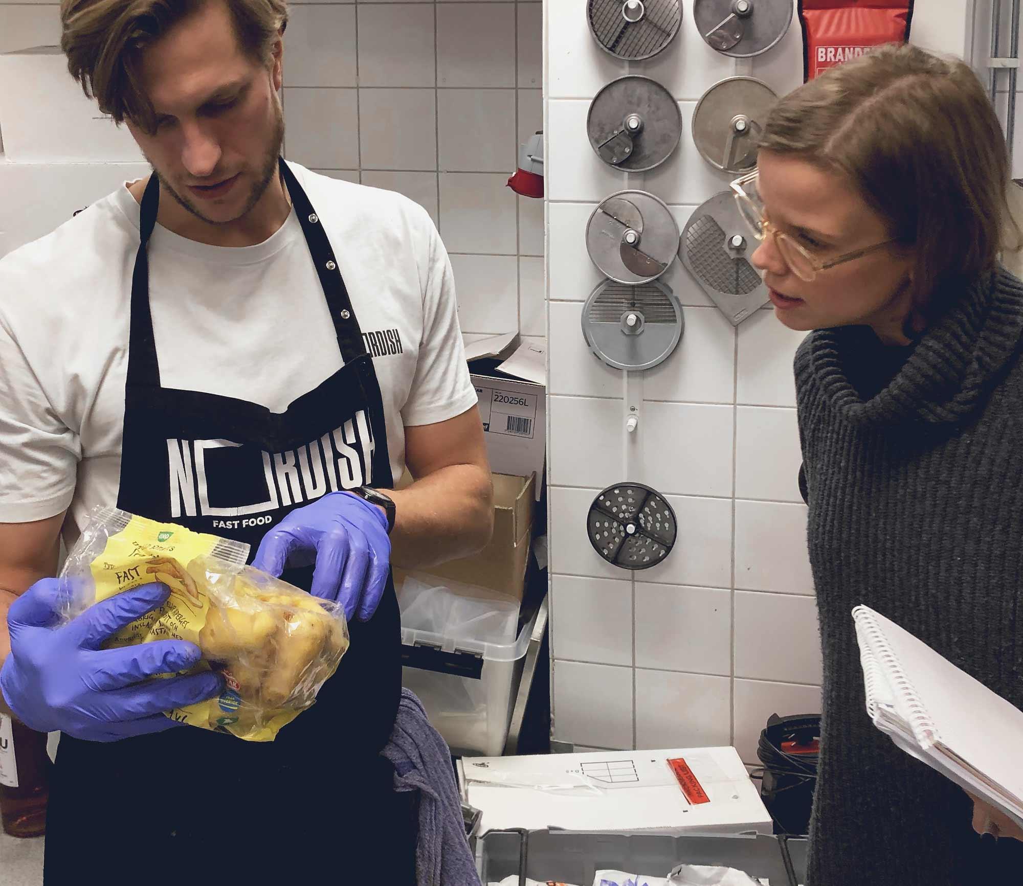 Study visit to a kitchen, a chef shows checks the expiry date on a raw material.