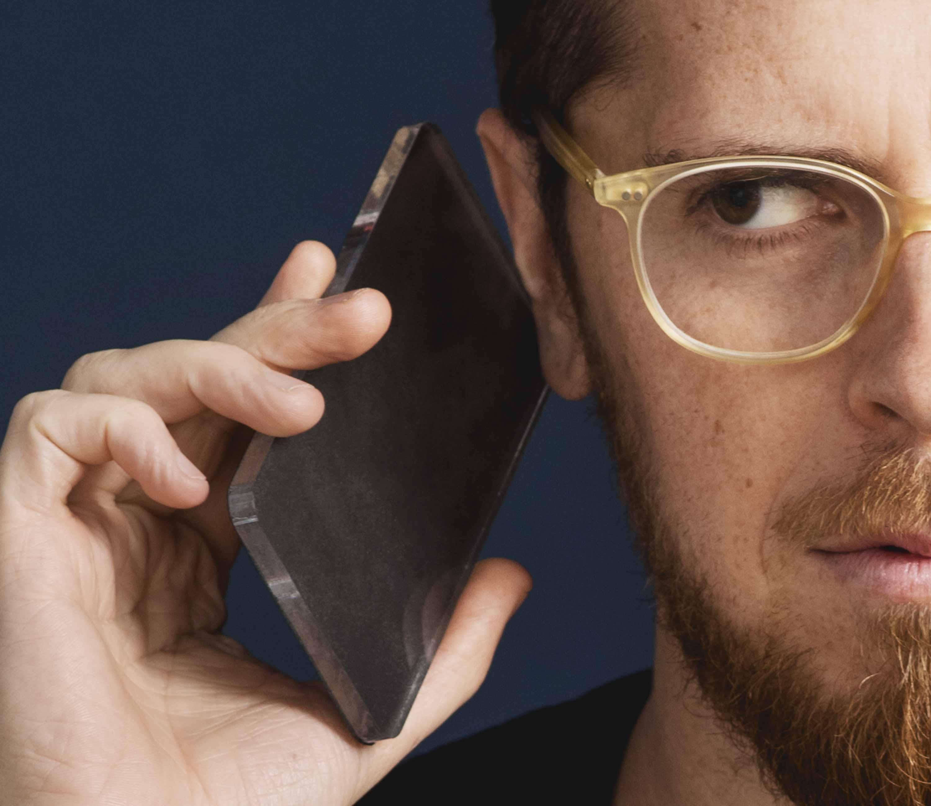 Person holding a smartphone-like prototype to their ear